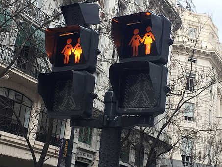 amber traffic light with girls holding hands