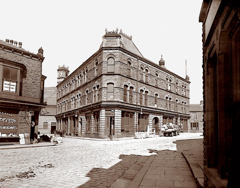 Also known as Co-op Buildings, the photo is taken from Albert Street. the White Horse Inn can be seen to the right of Carlton Buildings. The building just visiable on Crown Street was a foundary, it later became Sowden's blacksmith shop.